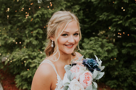 Junior bridal party member holding bouquet of flowers