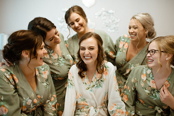Group of bridal party laughing and getting ready