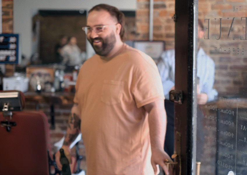 Animated gif of barber walking through door and smiling