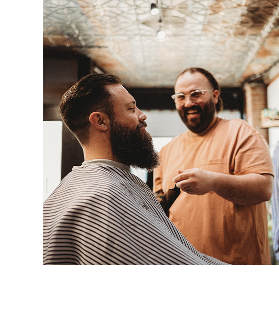 Barber laughing with client