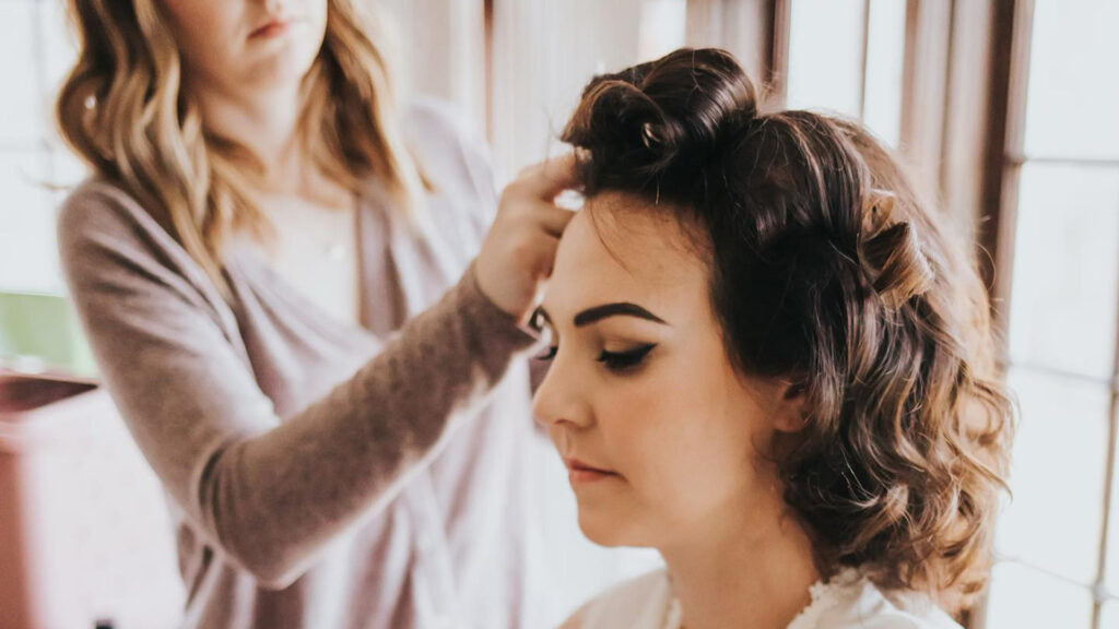 Stylist doing hair for a bridal party