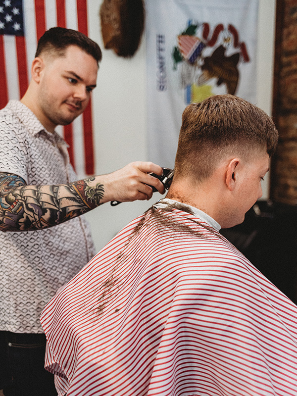 Barber trimming client's neck line